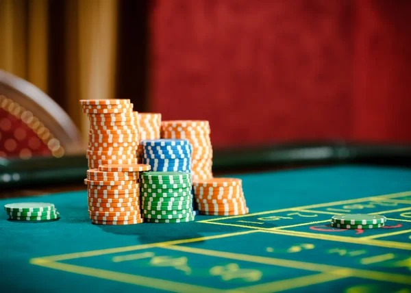 Live dealer at Adventures Beyond Wonderland blackjack table with themed studio backdrop
